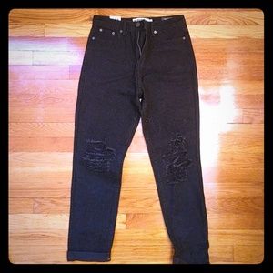 Black jeans with a rip in the knee